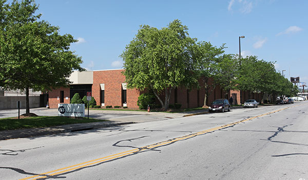 photo of building and road with trees.